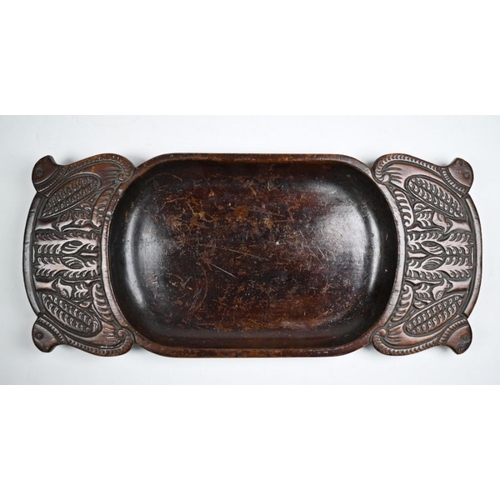 997 - A Polynesian carved wood ceremonial dish, the broad handles worked with stylised birds, 43 x 19 cm
