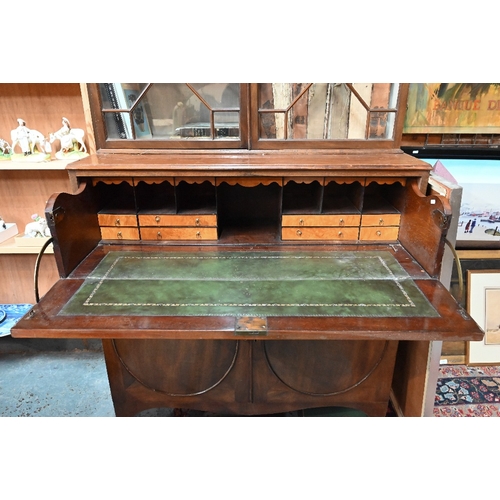 801 - A George III mahogany secretaire bookcase, the astragal glazed upper part two doors enclosing adjust... 