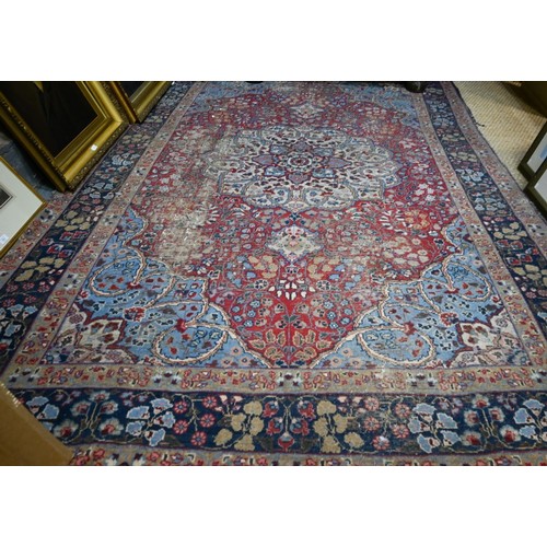 925 - An old Indian floral design carpet, worn and a/f 320 x 214 cm