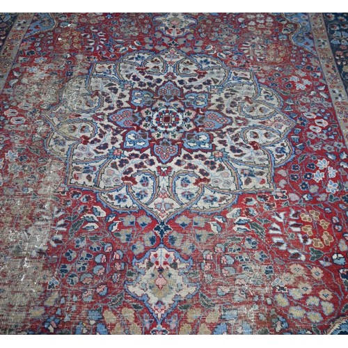 925 - An old Indian floral design carpet, worn and a/f 320 x 214 cm