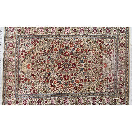 903 - A fine Turkish Hereke silk rug, the yellow/ochre ground centred by a floral medallion, 150 cm x 102 ... 