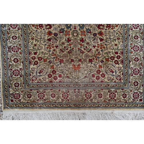 903 - A fine Turkish Hereke silk rug, the yellow/ochre ground centred by a floral medallion, 150 cm x 102 ... 