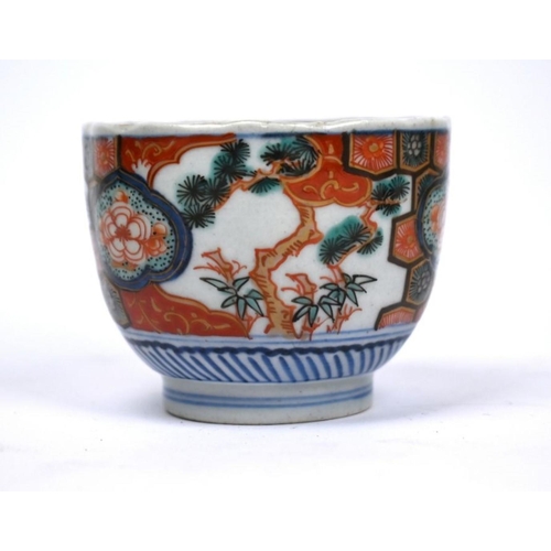 299 - A 19th century Japanese Arita floriform tea bowl, painted in underglaze blue and polychrome Imari pa... 
