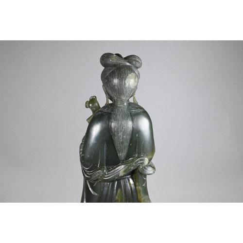301 - A 20th century Chinese carved green soapstone figure of a courtesan wearing traditional robes with f... 
