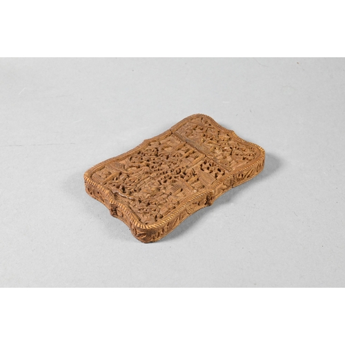 359 - A 19th century Chinese Canton sandalwood card case profusely carved with a village scene, dwellings ... 