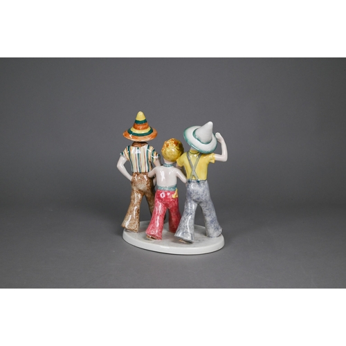 455 - A Goldscheider with Myott Son & Co. pottery group of three boys striding, 23 cm high, to/w two o... 