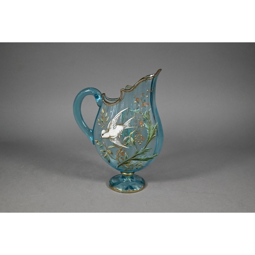 477 - A Continental blue glass jug of flattened form, painted with a bird in flight amongst foliage, 29 cm... 