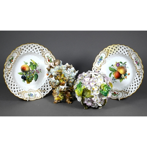 491 - A pair of Meissen wall-plates, finely painted with fruit and flowers, within pierced basketwork rims... 