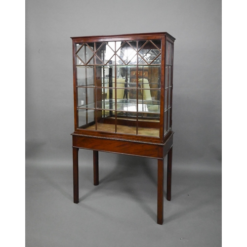 756 - A Georgian Chippendale style glazed mahogany display cabinet, raised on a converted mahogany card ta... 