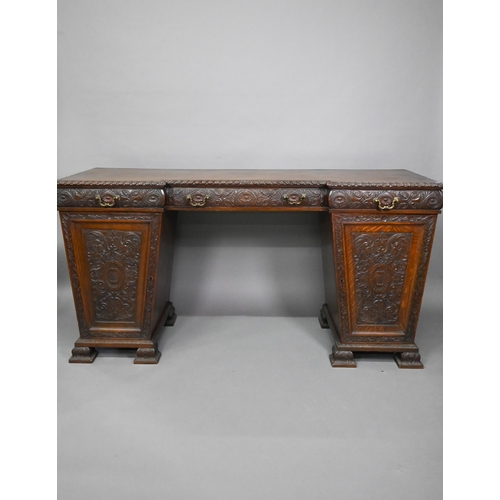 761 - A Victorian carved and moulded oak twin pedestal sideboard, the breakfront top over three frieze dra... 