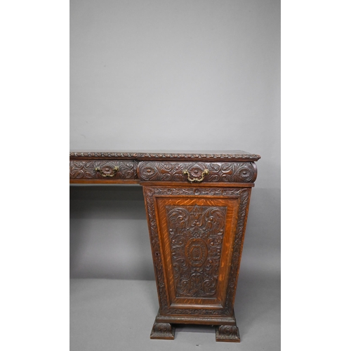 761 - A Victorian carved and moulded oak twin pedestal sideboard, the breakfront top over three frieze dra... 