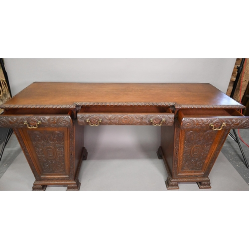 761 - A Victorian carved and moulded oak twin pedestal sideboard, the breakfront top over three frieze dra... 