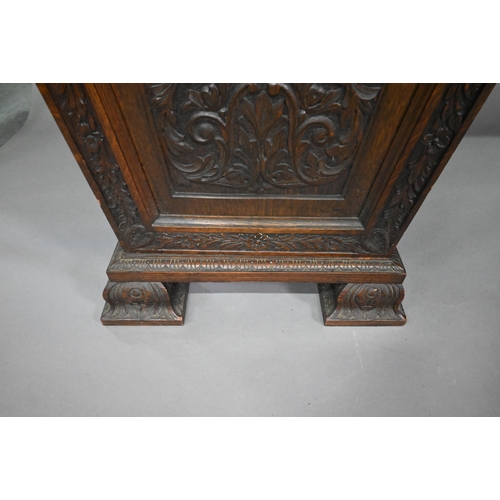 761 - A Victorian carved and moulded oak twin pedestal sideboard, the breakfront top over three frieze dra... 