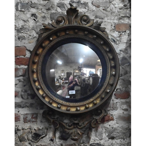 765 - A Victorian gilt framed convex mirror with applied moulded details. 87 cm h x 56 cm w o/all