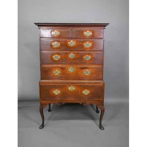 767 - An 18th century oak chest on stand comprising two short over four long graduated drawers, the stand ... 