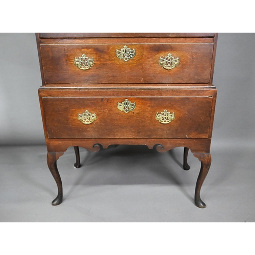 767 - An 18th century oak chest on stand comprising two short over four long graduated drawers, the stand ... 