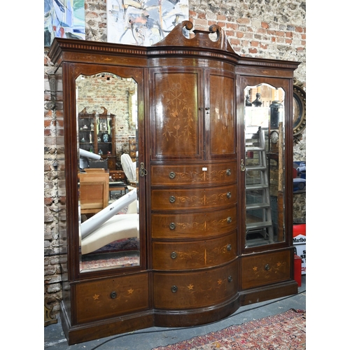 783 - A Victorian Sheraton Revival bowfront compactum, centred by a bowfront twin cupboard enclosing linen... 