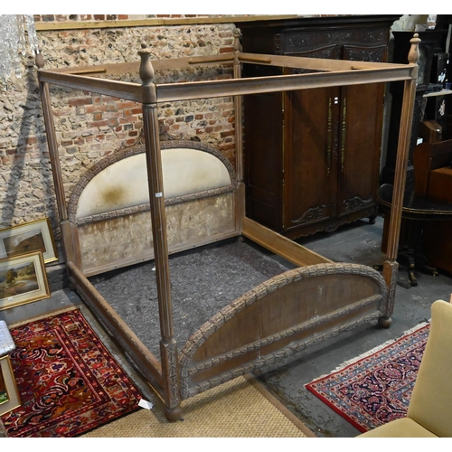 790 - A mid-century limed hardwood four poster bed, the end boards with carved border, of American origin,... 