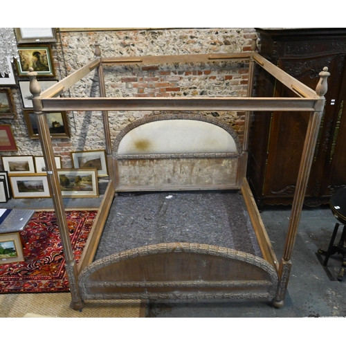 790 - A mid-century limed hardwood four poster bed, the end boards with carved border, of American origin,... 