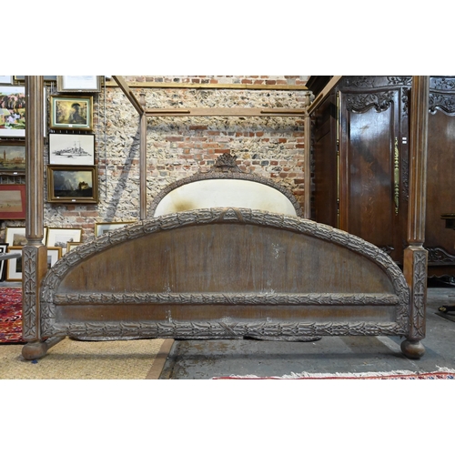 790 - A mid-century limed hardwood four poster bed, the end boards with carved border, of American origin,... 