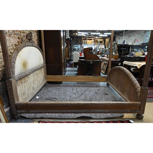 790 - A mid-century limed hardwood four poster bed, the end boards with carved border, of American origin,... 