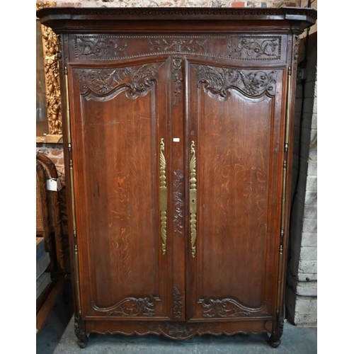 791 - A substantial 18th century French oak armoire, of pegged construction, with floral moulded decoratio... 