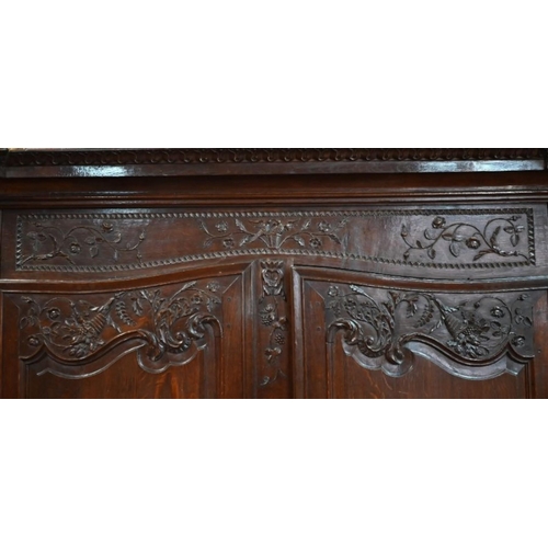 791 - A substantial 18th century French oak armoire, of pegged construction, with floral moulded decoratio... 