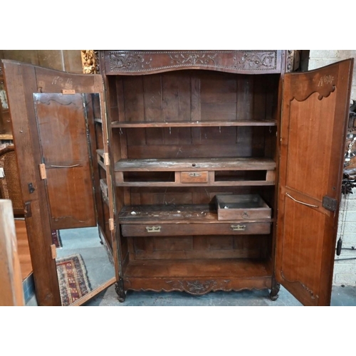 791 - A substantial 18th century French oak armoire, of pegged construction, with floral moulded decoratio... 