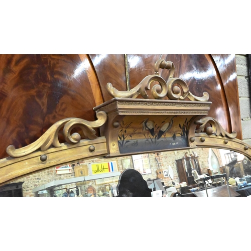 797 - A large Victorian giltwood and gesso overmantel mirror, the arched top centred by a polychrome depic... 