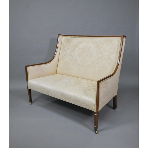 803 - A Sheraton Revival satinwood framed high back sofa, raised on square section front legs to brass cas... 