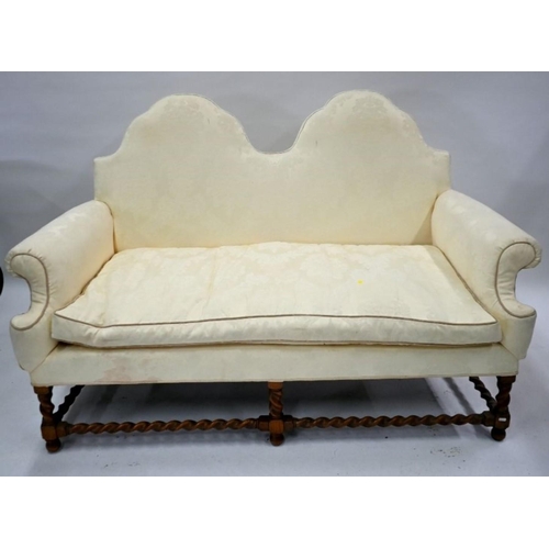 808 - A traditional Queen Anne style double hump-back sofa, raised on six oak barley twist legs united by ... 