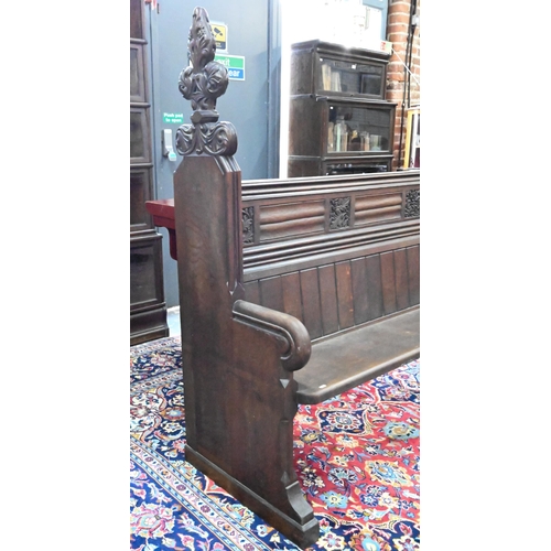 810 - A Victorian oak church pew with ornate carved ends, bible shelf to the reverse, circa 1870, 212 cm x... 