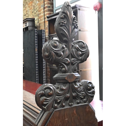 810 - A Victorian oak church pew with ornate carved ends, bible shelf to the reverse, circa 1870, 212 cm x... 