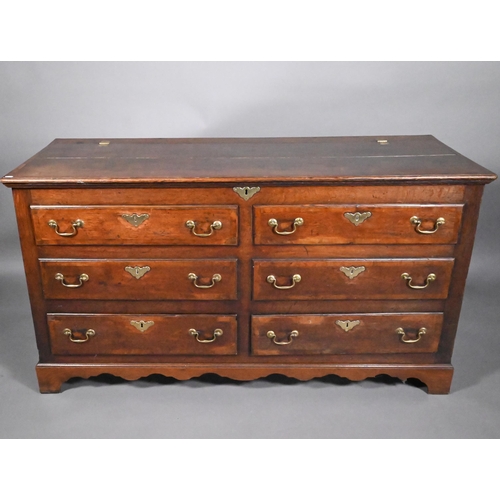 817 - An 18th century oak mule chest, the hinged top over four dummy drawer fronts and two drawers, with b... 