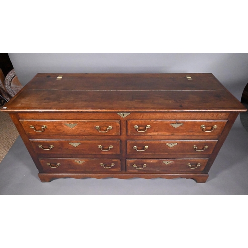 817 - An 18th century oak mule chest, the hinged top over four dummy drawer fronts and two drawers, with b... 