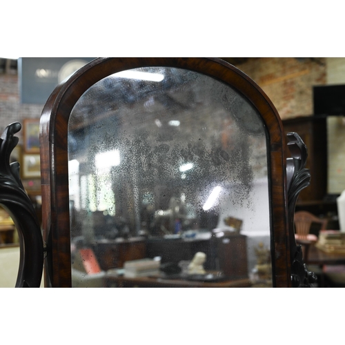 818 - A large Victorian mahogany toilet mirror raised on a serpentine platform base on scroll feet, 67 x 3... 