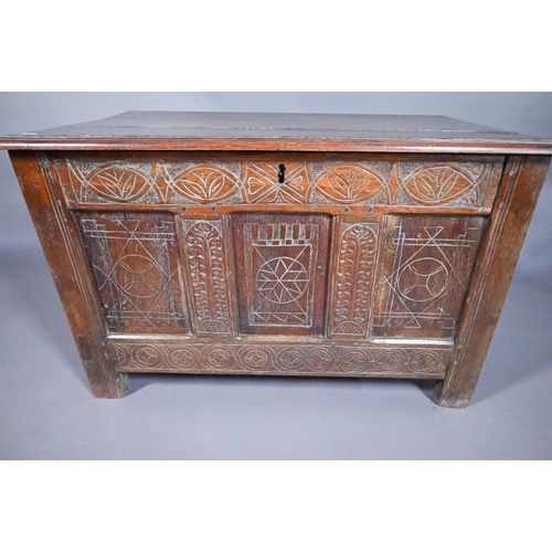 825 - An early 18th and later oak coffer, with lunette carved frieze over a trio of incised panels, on sti... 