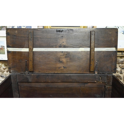 841 - A large Georgian oak coffer, the wide two plank top over a triple fielded panel front, raised on bun... 