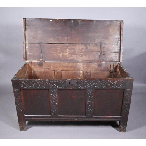 846 - A 17th century joint oak coffer, part carved, on stile feet 128 cm x 55 cm x 69 cm h