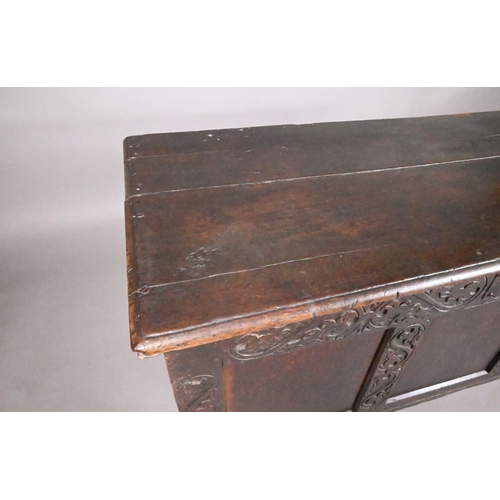 846 - A 17th century joint oak coffer, part carved, on stile feet 128 cm x 55 cm x 69 cm h