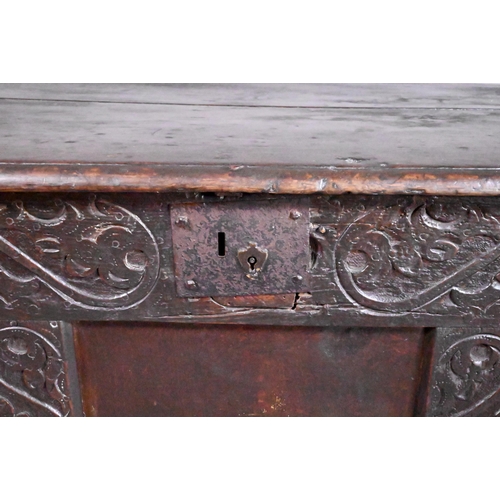 846 - A 17th century joint oak coffer, part carved, on stile feet 128 cm x 55 cm x 69 cm h