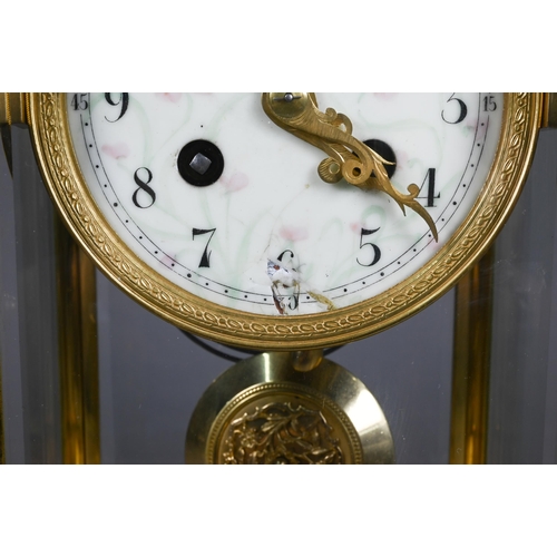 863 - A gilt metal four window mantel clock, the 8-day two train drum movement with white enamelled roman ... 