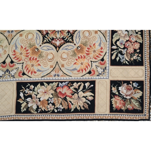 905 - A classic Aubusson style needlepoint rug, the floral design on ochre ground, 236 cm x 180 cm