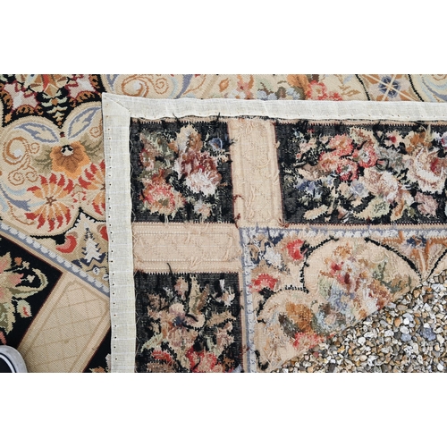 905 - A classic Aubusson style needlepoint rug, the floral design on ochre ground, 236 cm x 180 cm