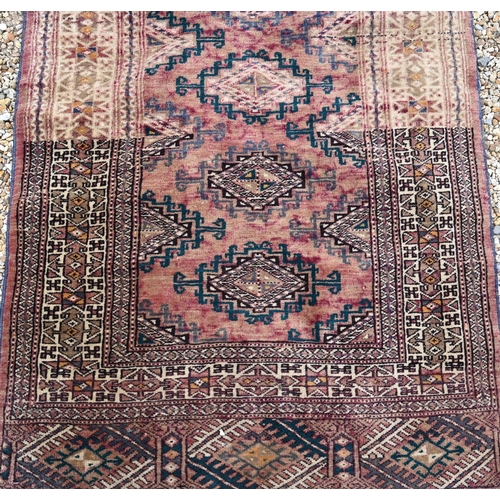 911 - An old Afghan washed red ground runner, 281 cm x 76 cm