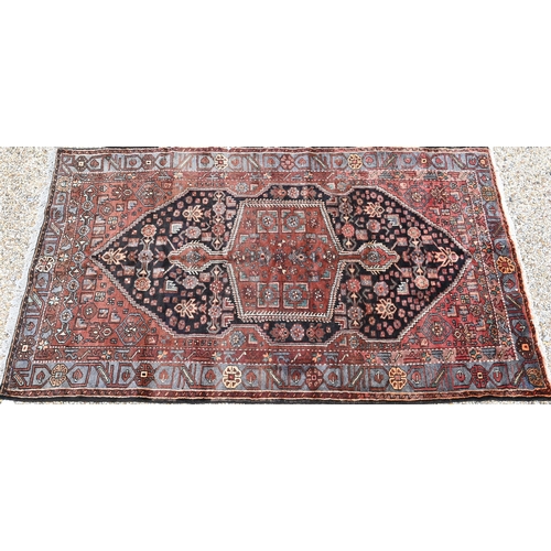 912 - A contemporary Persian Zanjan rug, the brown/blue ground centred by a medallion, 255 cm x 152 cm