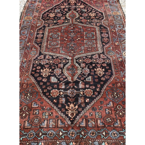 912 - A contemporary Persian Zanjan rug, the brown/blue ground centred by a medallion, 255 cm x 152 cm