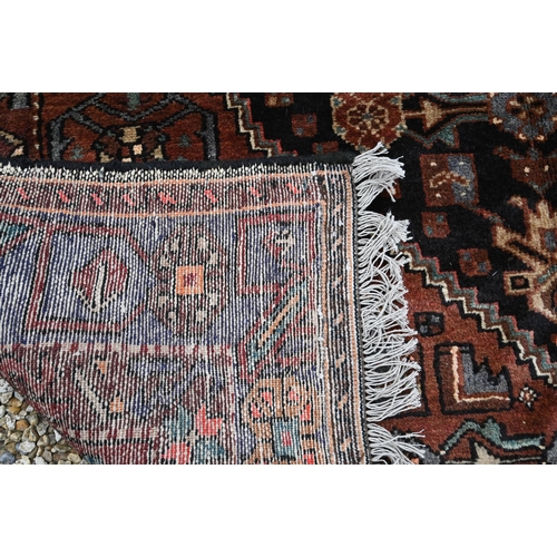 912 - A contemporary Persian Zanjan rug, the brown/blue ground centred by a medallion, 255 cm x 152 cm