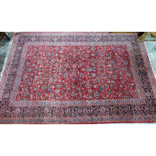 916 - A fine old Persian hand-made Kashan carpet, the red ground with repeating linked garden vine design,... 