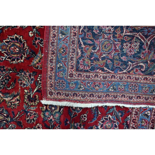 916 - A fine old Persian hand-made Kashan carpet, the red ground with repeating linked garden vine design,... 